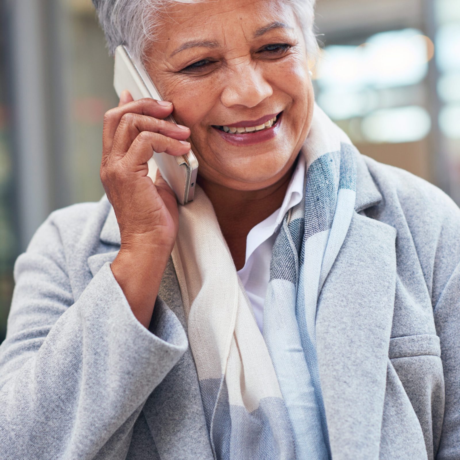 City, phone call and smile, mature woman at office, successful discussion on legal advice. Ceo, lawyer or businesswoman on sidewalk outside court with 5g smartphone, crm or networking conversation